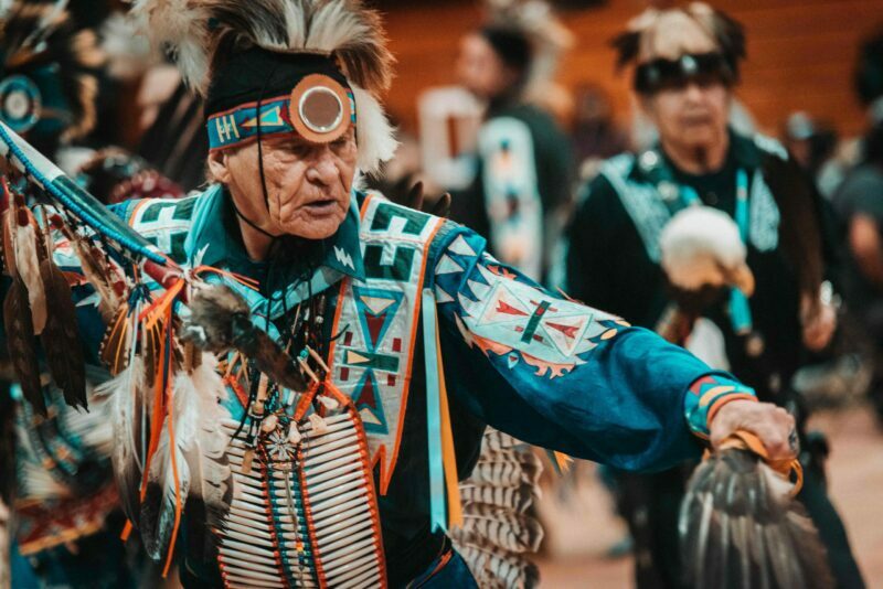 A dancer is focused on his performance at a powwow of Pacific Northwest Indigenous peoples